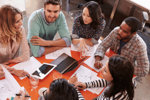 Team of colleagues discussing around a table