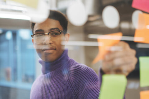 Man putting up sticky notes
