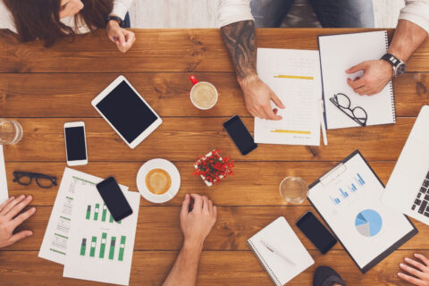 people at a conference table as seen from above them